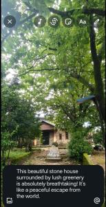 a sign in front of a house under a tree at Rimaaia homestay in Lāitlyngkot
