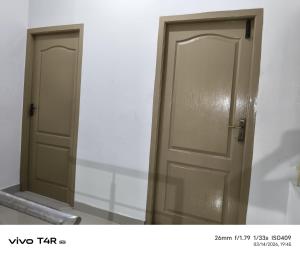 a pair of doors sitting next to each other at Kmr villa in Madurai