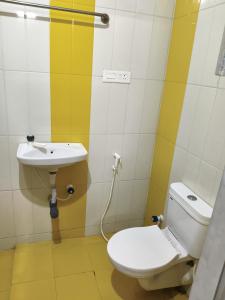 a bathroom with a toilet and a sink at Kmr villa in Madurai