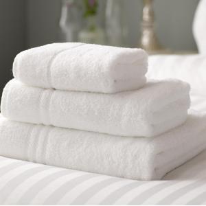 a stack of white towels stacked on a table at Leeds City Apartment in Leeds