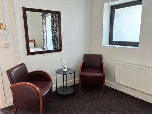 a waiting room with two chairs and a mirror at Edenderry Central Rooms in Edenderry