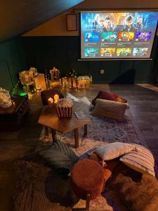 a living room with a tv and a table and chairs at Le grenier des sorciers in Balbigny +21 photos