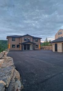 a large house with a driveway in front of it at Trysil turistesenter hytte in Trysil