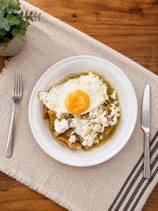 a white plate with an egg on top of food at Hotel Boutique Piedra & Altura in San Juan Teotihuacán