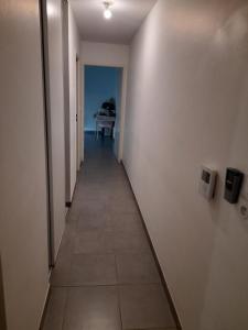 a hallway leading to a room with a table at Appartement in Tournefeuille