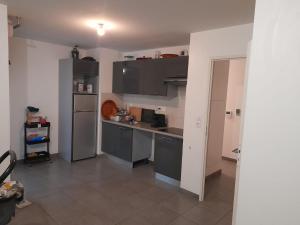 a kitchen with gray cabinets and a counter top at Appartement in Tournefeuille