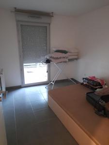 a room with a couch and a door with a window at Appartement in Tournefeuille