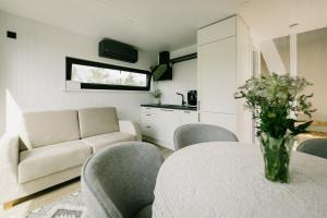a living room with a table and chairs and a couch at Majakavahi in Sääre