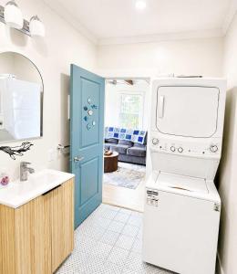 a kitchen with a sink and a washer and dryer at Wild Cove Nook in Twillingate