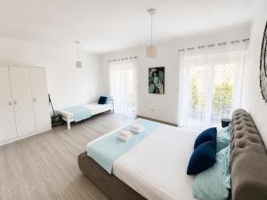 a bedroom with a large bed and a couch at Banićević APARTMANI in Đenovići