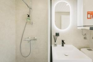 a bathroom with a shower and a sink at Majakavahi in Sääre +14 photos