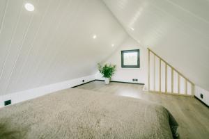 a bedroom with a large bed in a attic at Majakavahi in Sääre