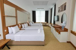 a hotel room with two beds and a television at Kule Hotel&Spa Gaziantep in Şahinbey