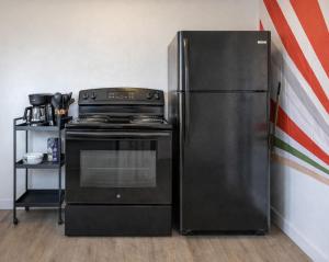 a kitchen with a stove and a refrigerator at Pet-Friendly Near Zion - Hot Tub Downtown Kanab in Kanab +60 photos