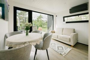 a living room with a table and chairs and a couch at Majakavahi in Sääre