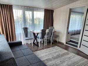 a living room with a dining room table and chairs at Valentina`s Guesthouse in Korumdy +17 photos