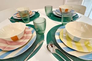 a table with plates and bowls and glasses on it at Villa Lucia in Torre del Greco
