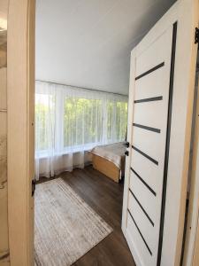 a bedroom with a bed and a window at Valentina`s Guesthouse in Korumdy
