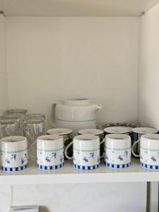 a shelf with blue and white dishes on it at Rakkez's house in Hiboun