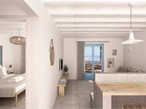 a white bedroom with a bed and a table at Serifos Blue in Rámos
