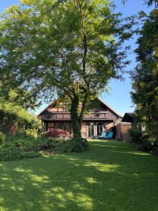 a large tree in front of a house at Lake House Ternsche in Selm