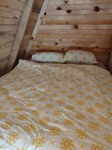 a bed with two pillows on it in a room at Vikendica Hećo in Višegrad +11 photos