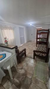 a living room with a table and a chair at Kitnetilha in Itamaracá