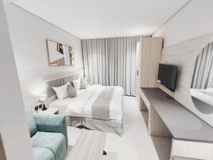 a hotel room with a bed and a tv at شقق الإيجار - العروبه in Riyadh