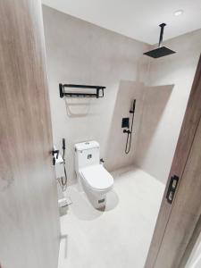 a bathroom with a white toilet in a stall at شقق الإيجار - العروبه in Riyadh +56 photos