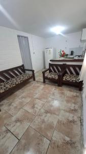 a room with two benches and a table in it at Kitnetilha in Itamaracá +1 photo