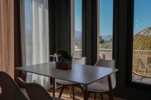 a table and chairs in a room with a window at Villa Velvet Chios in Chios