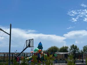 a playground with a basketball hoop and a ball at Atlantis Resort Коттеджи-таунхаузы in Chon-Sary-Oy