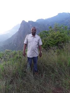 a man standing in a field of tall grass at Sheiza in Kampala
