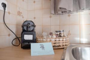 a tea kettle sitting on a counter next to a sink at Dionysus House Lasithi Plateau in Magoulás +91 photos