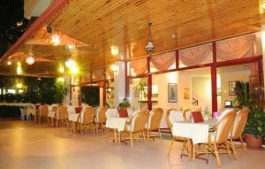 a dining room with tables and chairs in a building at Amber-Rose Apart Hotel in Alanya