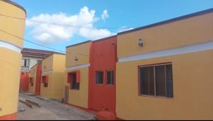 a row of colorful buildings on a street at Monarch Appartement in Oshogbo