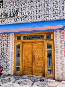 a large wooden door on a brick building at umer cottage in Murree +4 photos