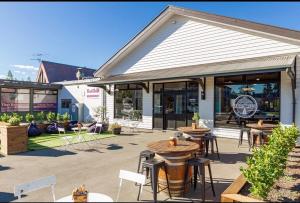 a restaurant with tables and chairs outside of a building at Alpine Retreat in Methven