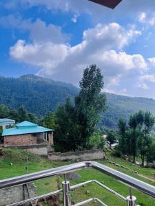 a view from the balcony of a house at umer cottage in Murree