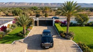 a car parked in the driveway of a house at Villa El Houda in Souk el Had du Drâa