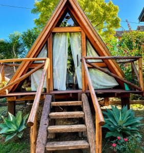 a tree house with a staircase leading up to it at Recanto agape chalés e cabana in Rosas