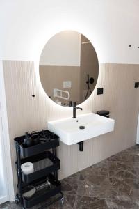a bathroom with a white sink and a mirror at Brighella in Putignano +15 photos