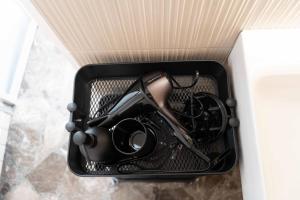 a black container with a pair of scissors in it at Brighella in Putignano