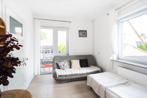 a living room with a couch and a window at Pokoje Złota Plaża in Międzywodzie