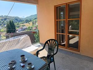 a table and chair on a balcony with a view at Ljiljana Apartman 1 in Rakari