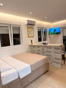 a bedroom with a large bed in a room with windows at IK Apartments in Rake
