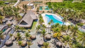 an aerial view of a resort with a pool and palm trees at El Viento Beach Apartamentos in San Bernardo del Viento +1 photo