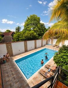 a group of people swimming in a swimming pool at B&B Villa CALASAN in Garzón +79 photos
