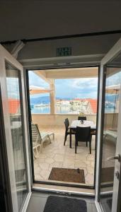 a view of a patio with a table and chairs at Stunning Sea View in Central Postira in Postira