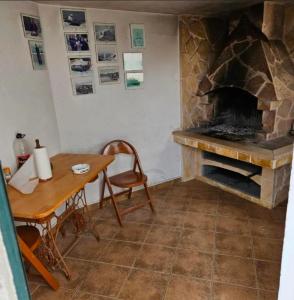 a living room with a stone fireplace and a table at Stunning Sea View in Central Postira in Postira +28 photos